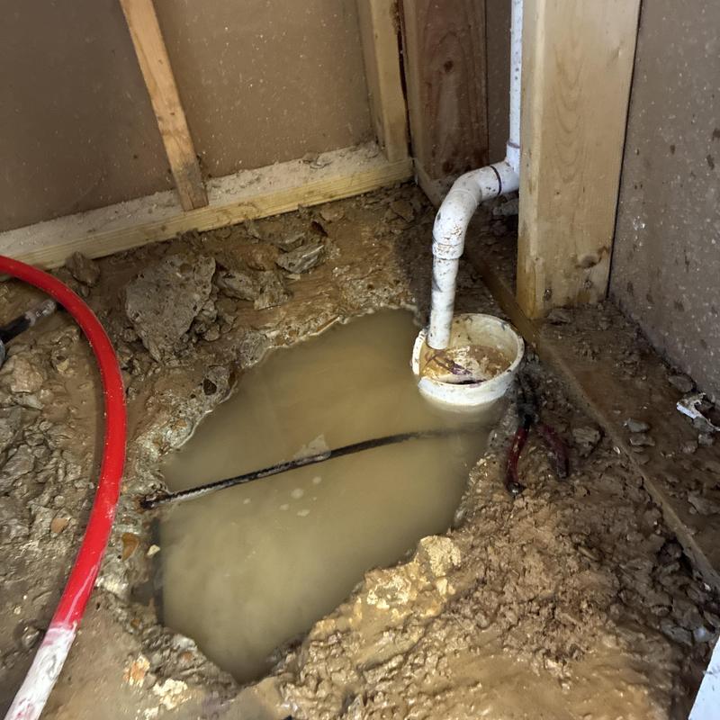 Slab leak water accumulation near PVC drain pipe