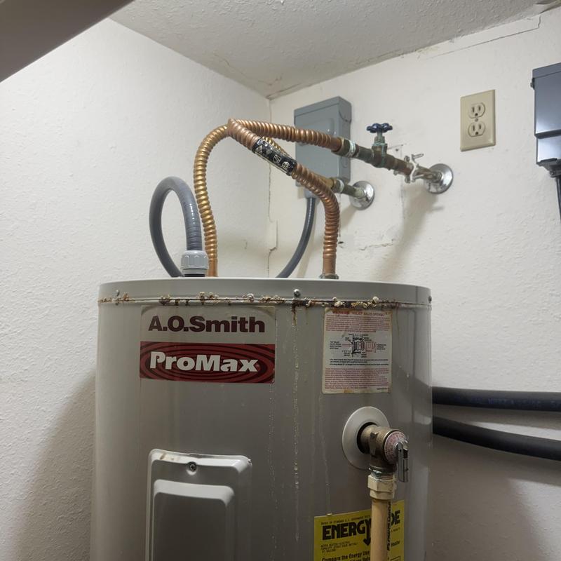 Electric water heater with leaking tank and piping