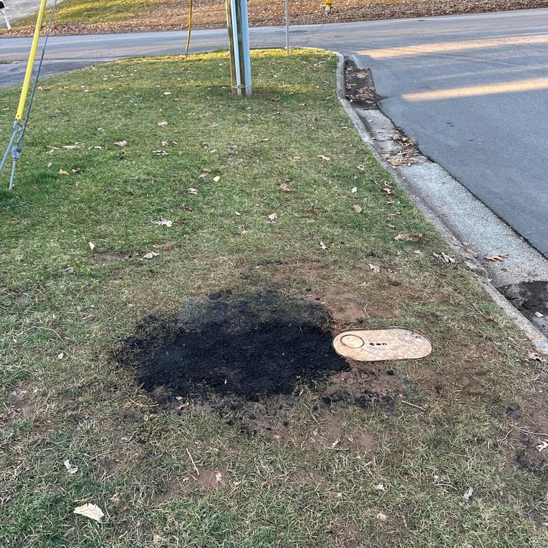 Water valve box on lawn with burnt grass patch Water valve box on lawn with burnt grass patch