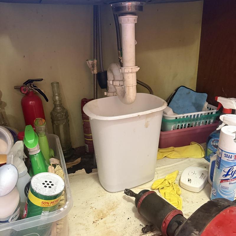 Kitchen sink drain clogged, cable auger cleaning in progress