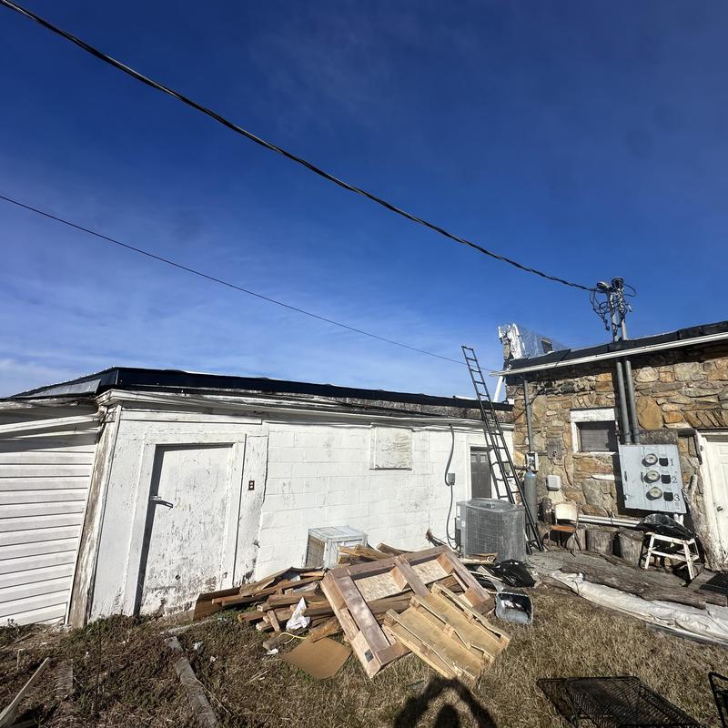 Flat roof with replacement materials and ladder outdoors