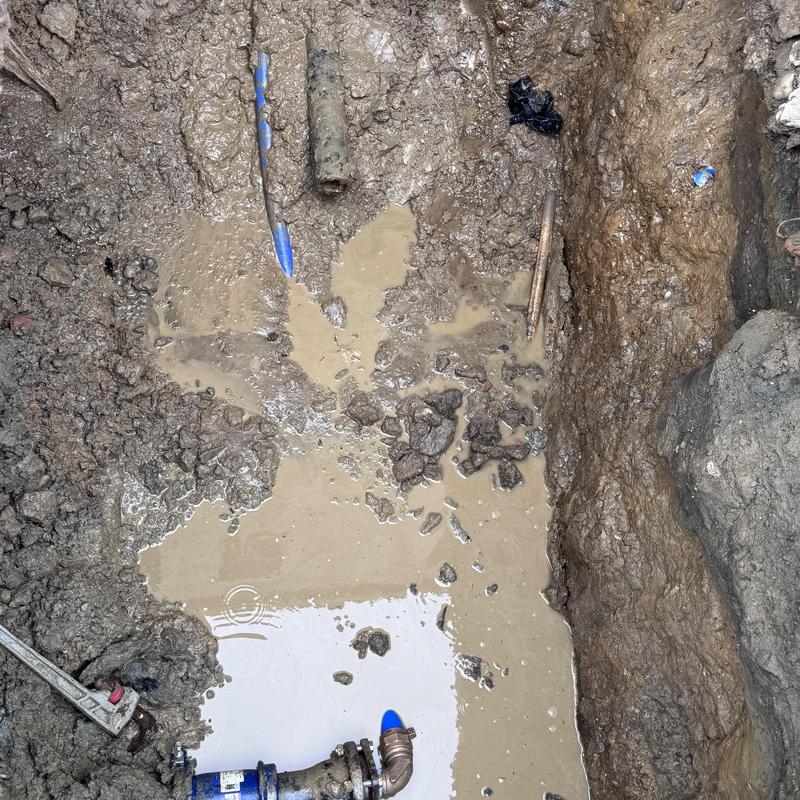 Ductile water line and 2-inch poly pipe leak repair site