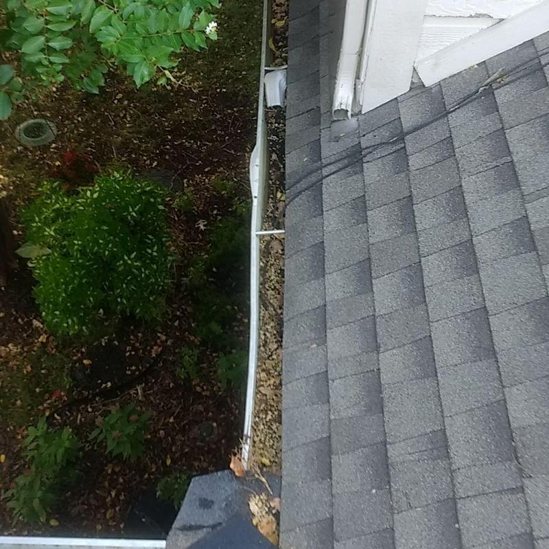 Gutter system alongside new shingle roof edges