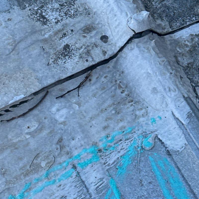 Roof membrane with cracks and hail damage markings