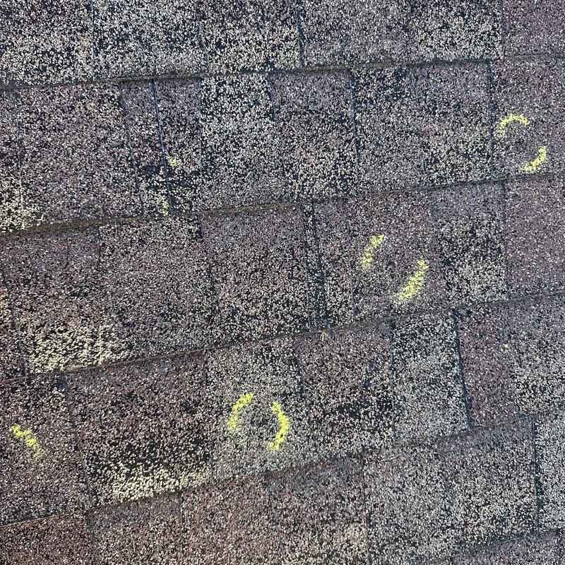 Roof shingles with marked hail damage spots