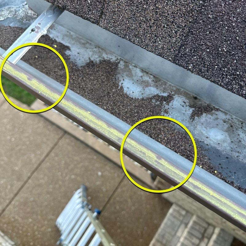 Gutter interior with hail damage and granule buildup