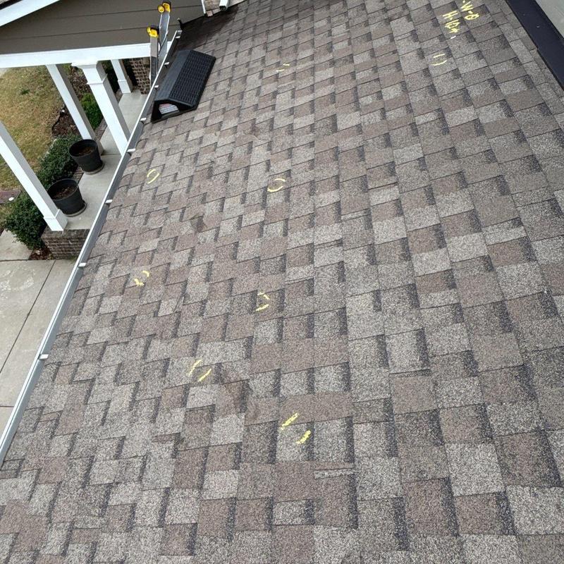 Asphalt shingle roof with hail damage markings
