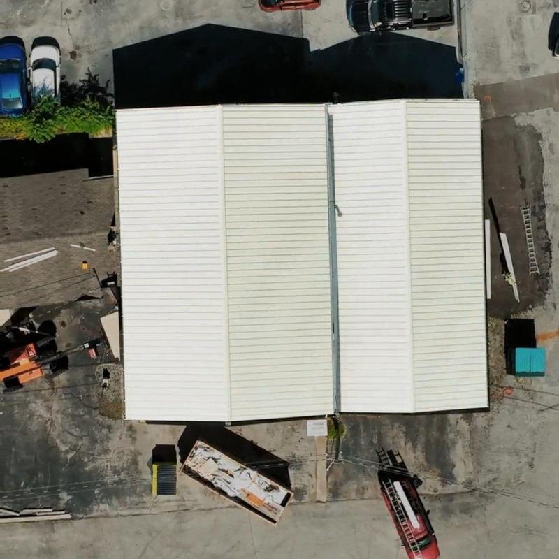 Commercial metal roof inspection showing panels and drainage