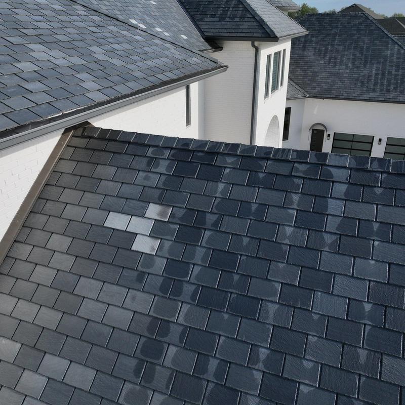 Slate roof tiles with hail damage and discoloration