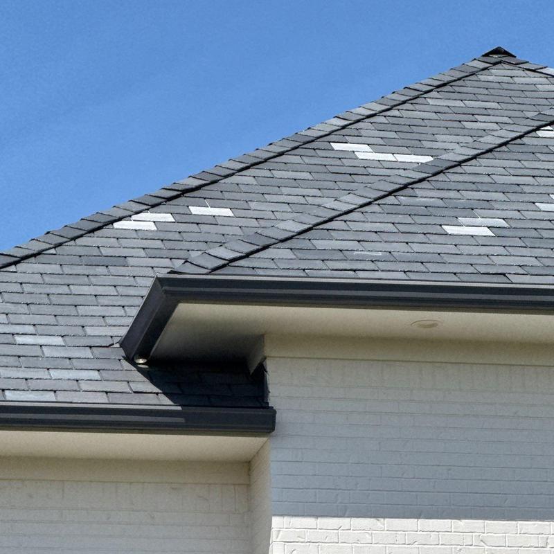 Roof shingles with hail damage marked for inspection