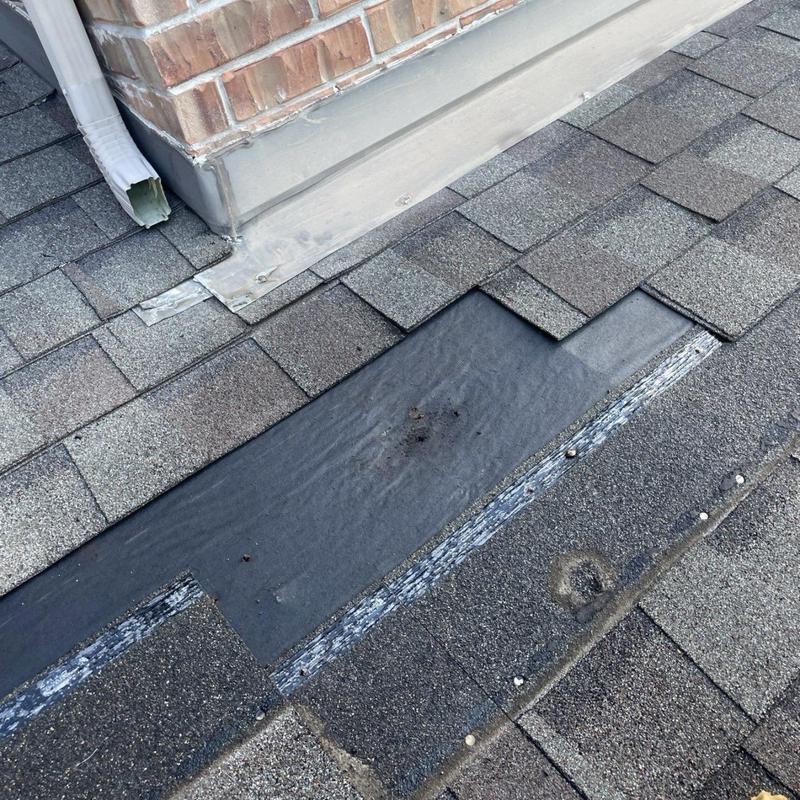 Chimney flashing with new underlayment on shingle roof