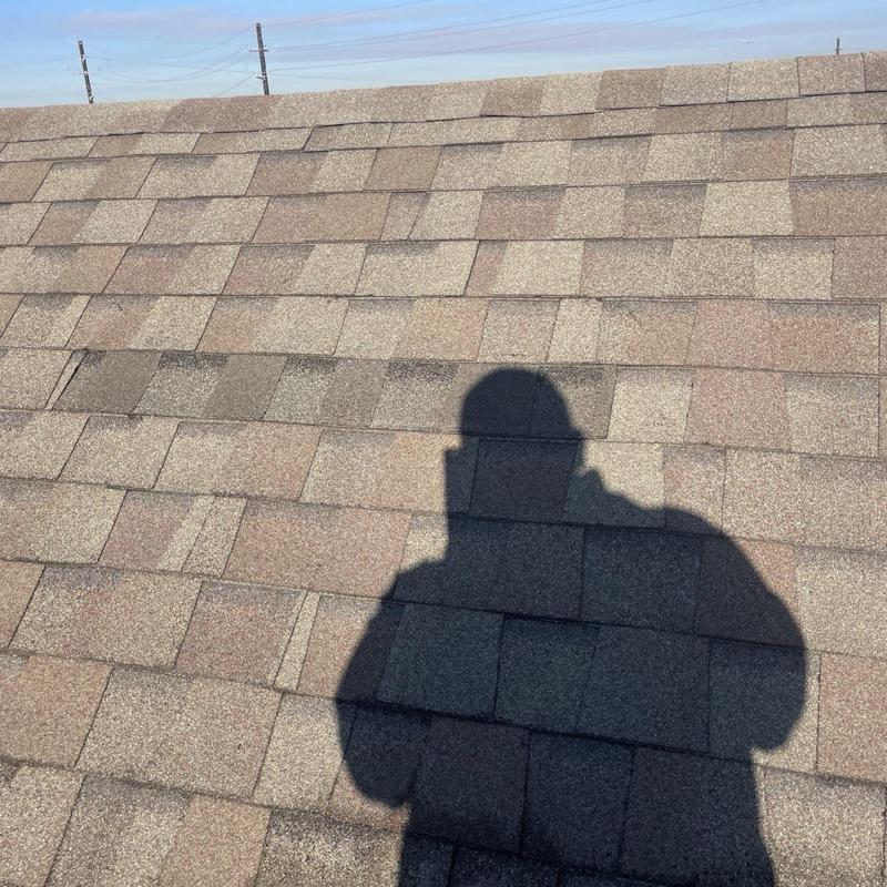 Asphalt shingle roof inspection with shadow on shingles