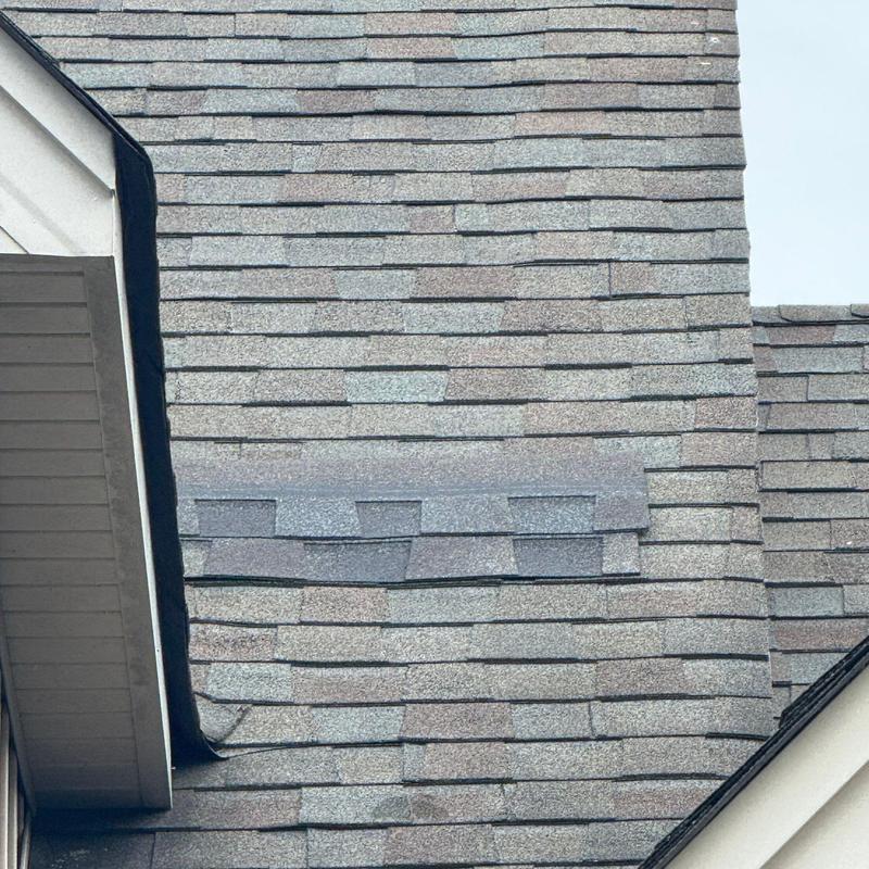 Asphalt shingles with hail damage and repair patch