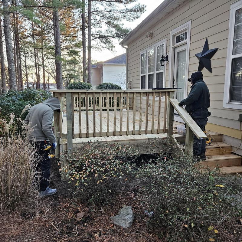 Wood deck railing installation on residential outdoor space