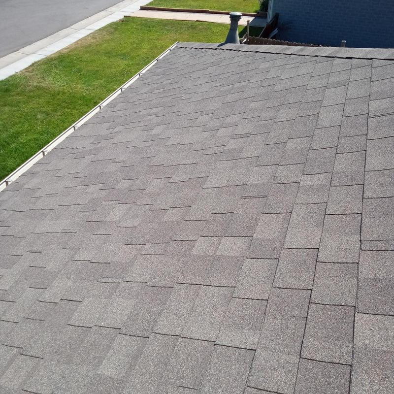 Asphalt shingle roof with resealed nail heads and flashing Asphalt shingle roof with resealed nail heads and flashing