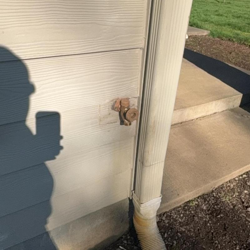 Frost-free exterior hose bib installed on siding wall