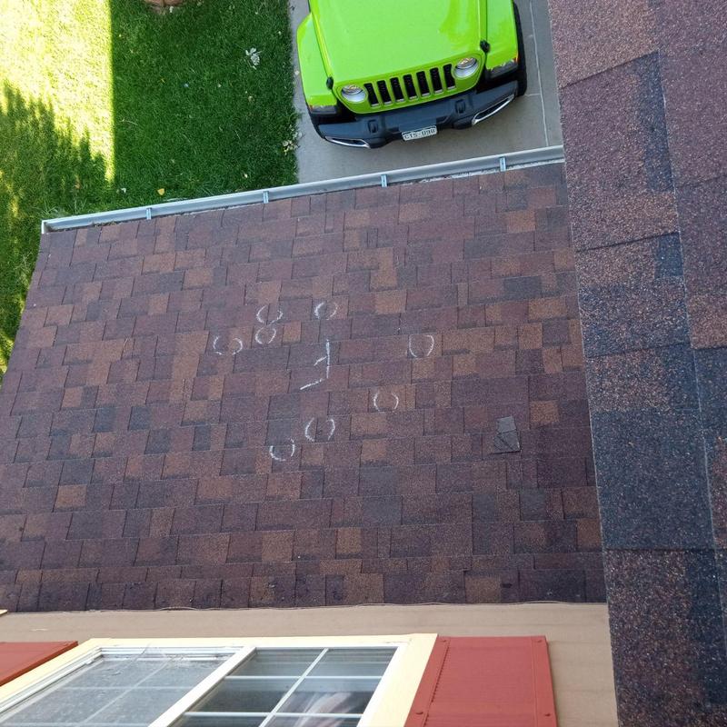 Asphalt shingle roof with hail damage markings Asphalt shingle roof with hail damage markings