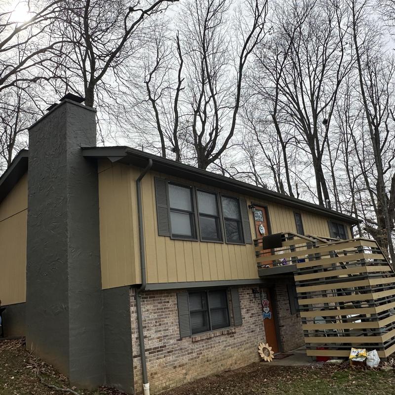 Residential asphalt shingle roof on split-level home