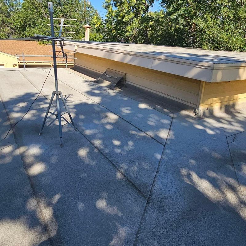 Flat roof with visible seams and aging signs Flat roof with visible seams and aging signs