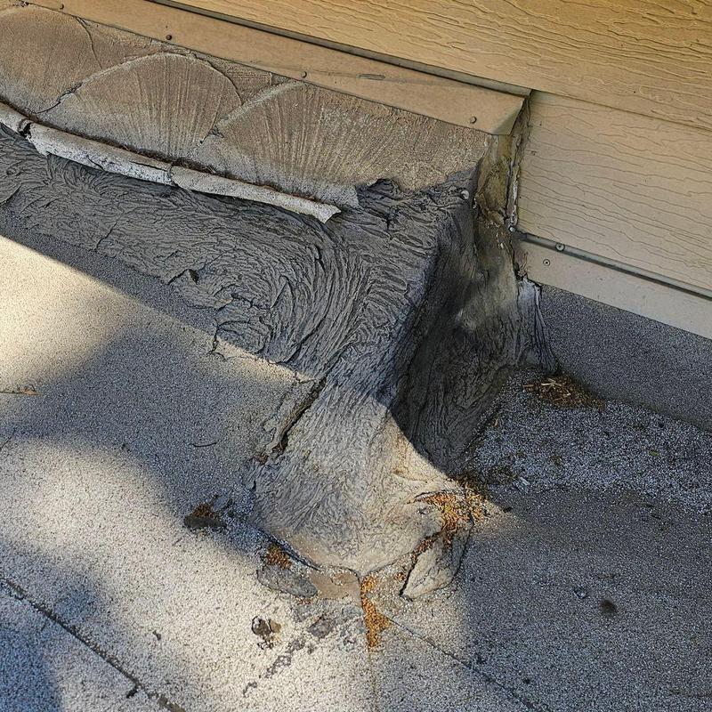 Flat roof seam with aged, cracked sealant near wall junction Flat roof seam with aged, cracked sealant near wall junction