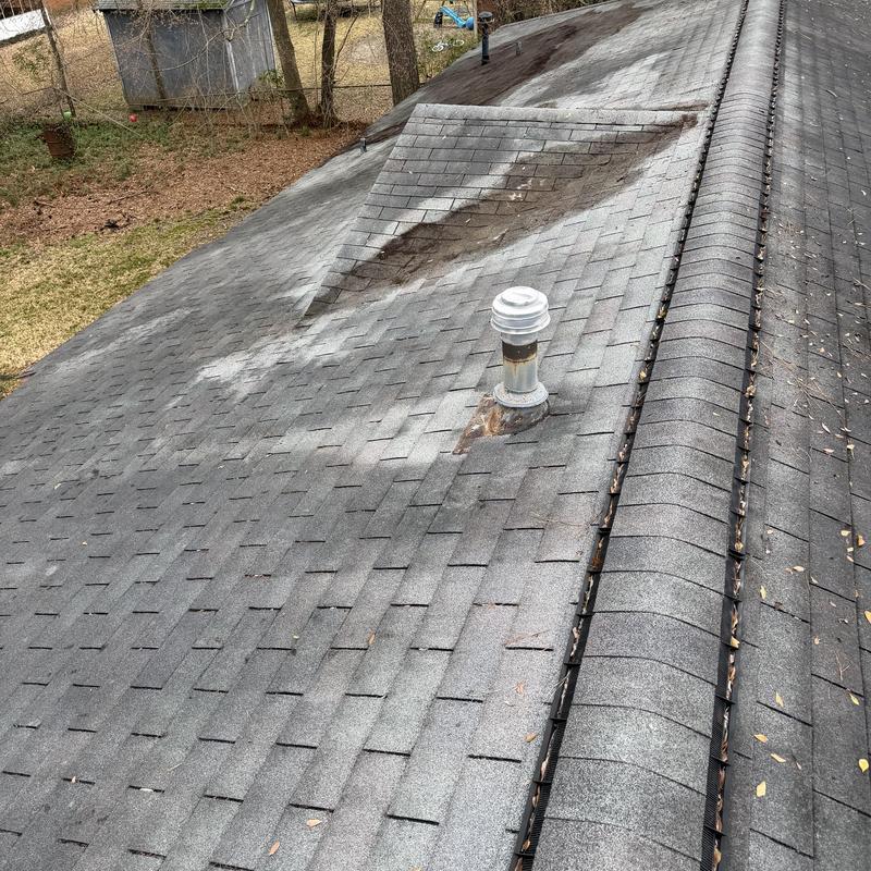 Asphalt shingle roof with vent pipe and ridge cap inspection