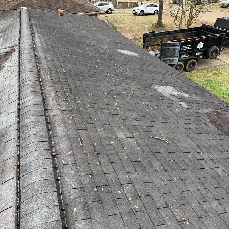 Asphalt shingle roof with damaged and missing shingles