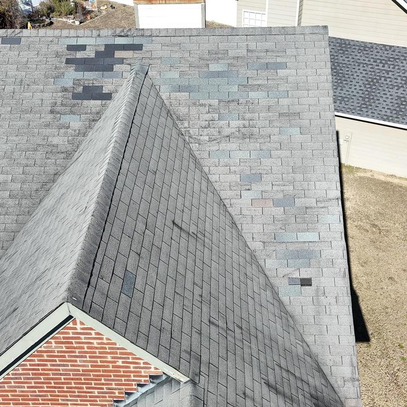 Asphalt shingles roof with multiple missing and damaged shingles