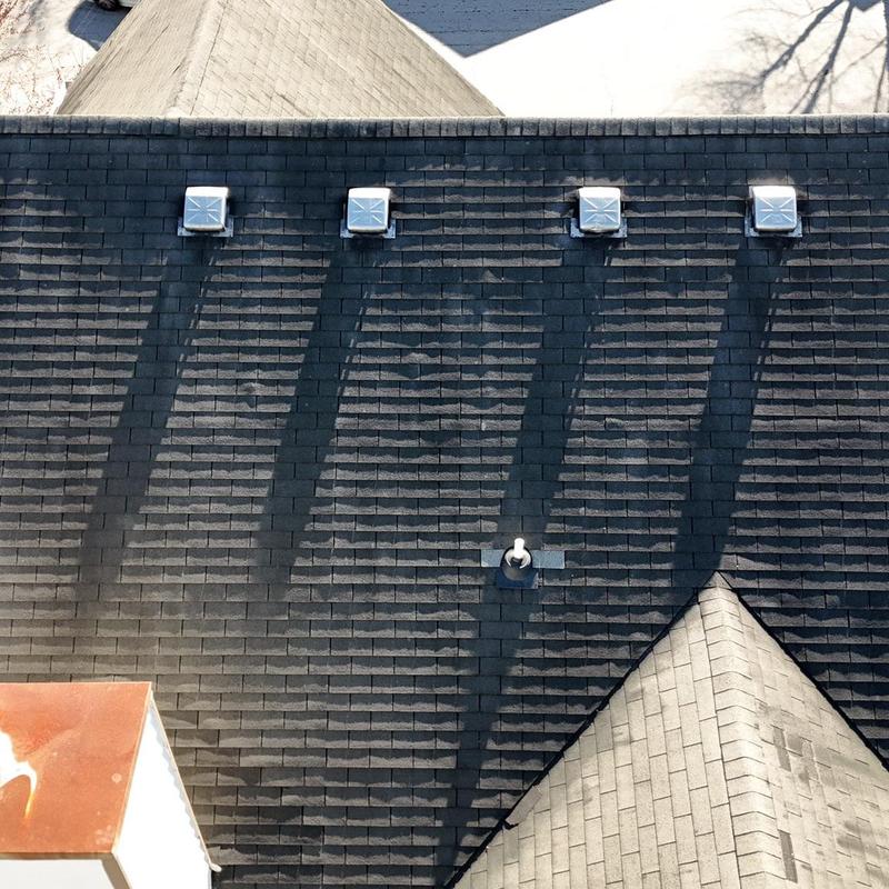 roof shingles with vent pipes and weathered shingles