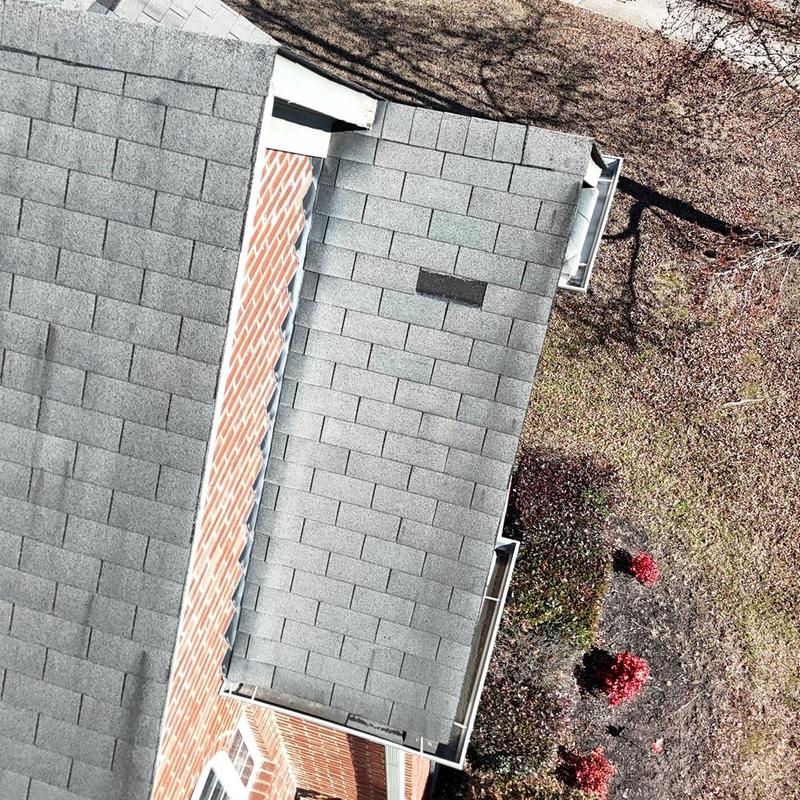 Roof shingles missing and damaged on home roof section