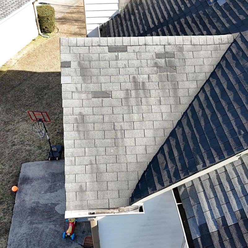 Shingles on roof with visible damage and wear