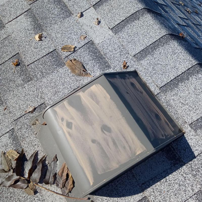 Roof vent with visible hail damage and debris Roof vent with visible hail damage and debris