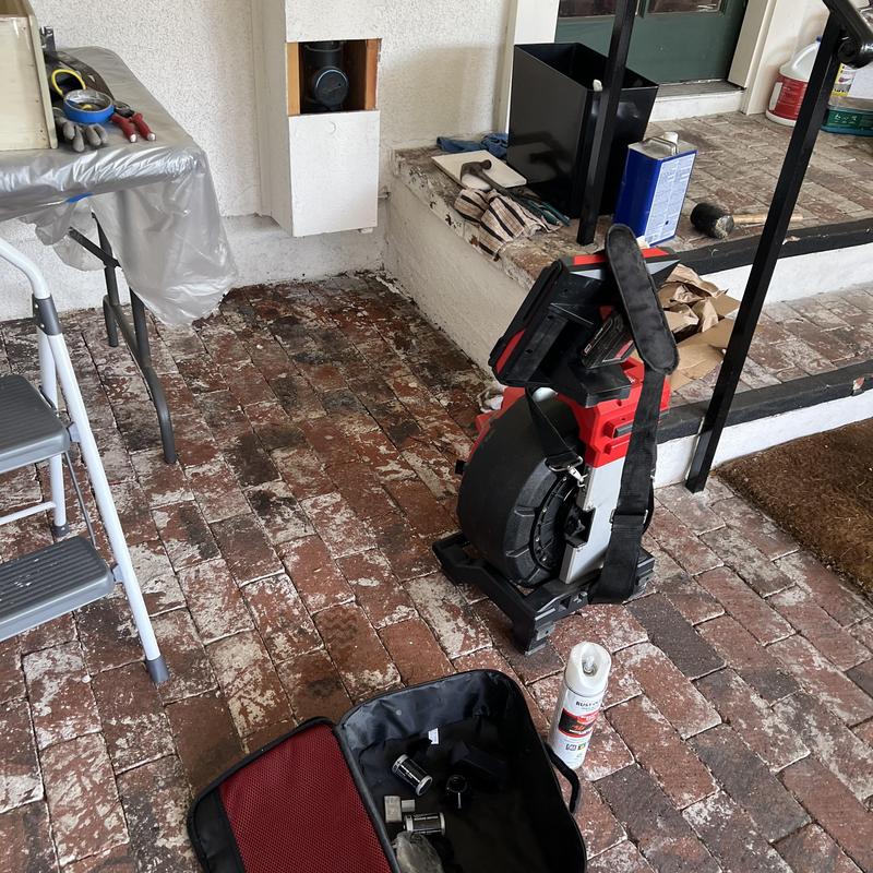 Sewer line camera inspection equipment on brick floor