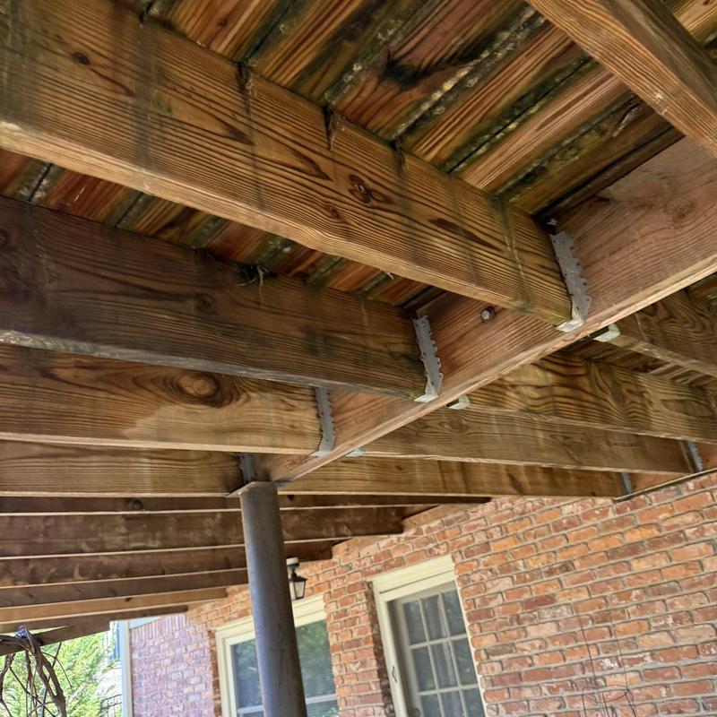 Wooden deck joists and support post under deck structure