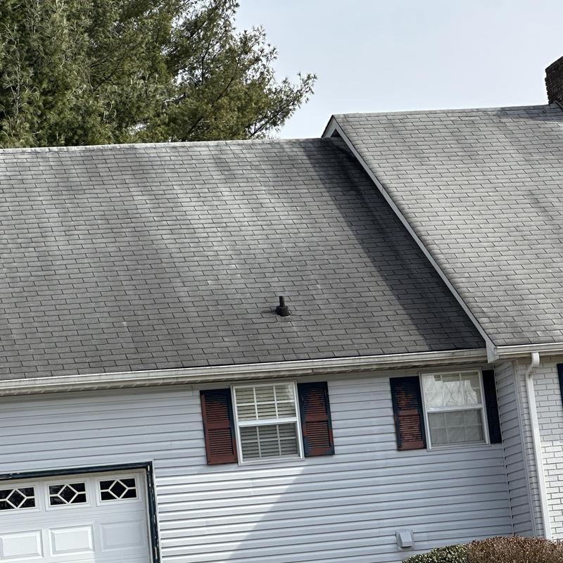 Asphalt shingle roof with ventilation pipe in residential home