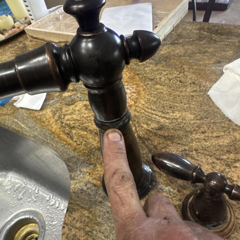 Delta faucet base with worn or leaking seal on granite counter