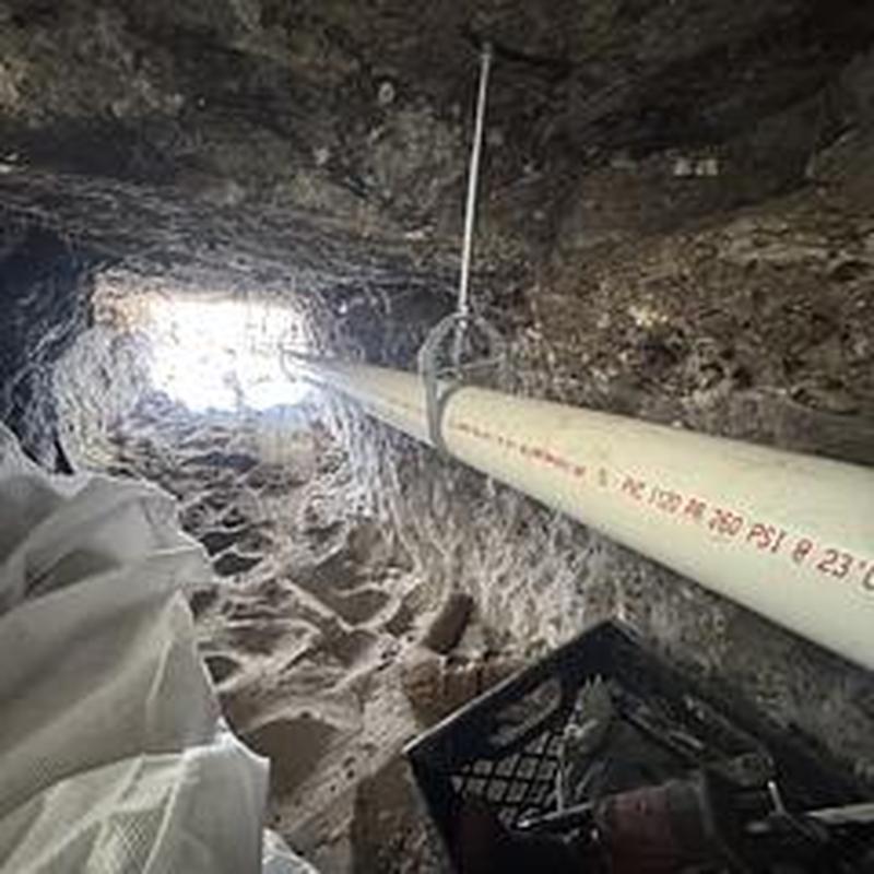 PVC sewer drain pipe hung in tunnel under slab