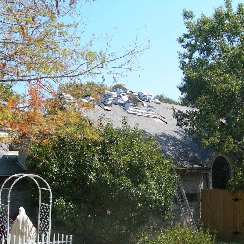 Asphalt roofing shingles stacked for installation on home Asphalt roofing shingles stacked for installation on home