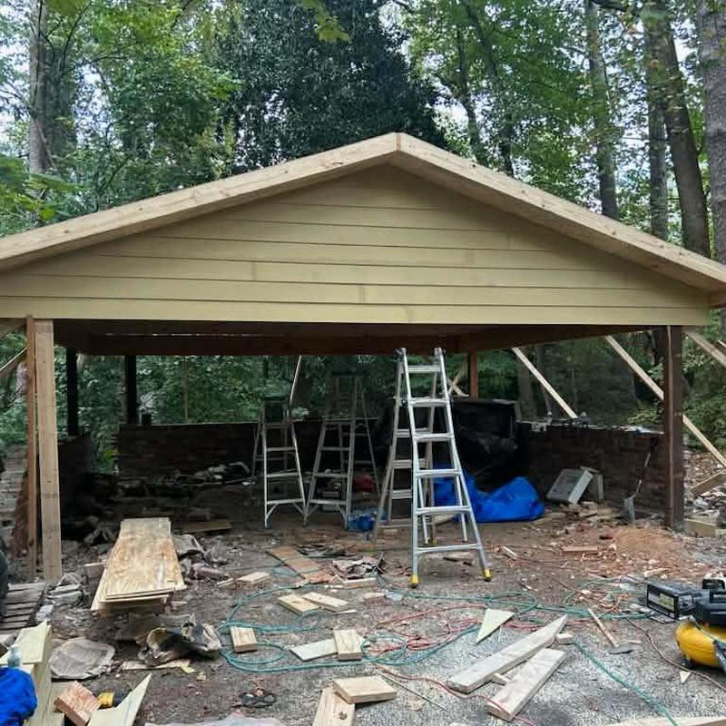 Carport roof structure with ladders and construction tools