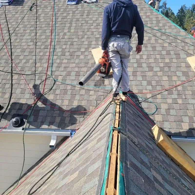 Asphalt shingle roof replacement with roofing worker Asphalt shingle roof replacement with roofing worker
