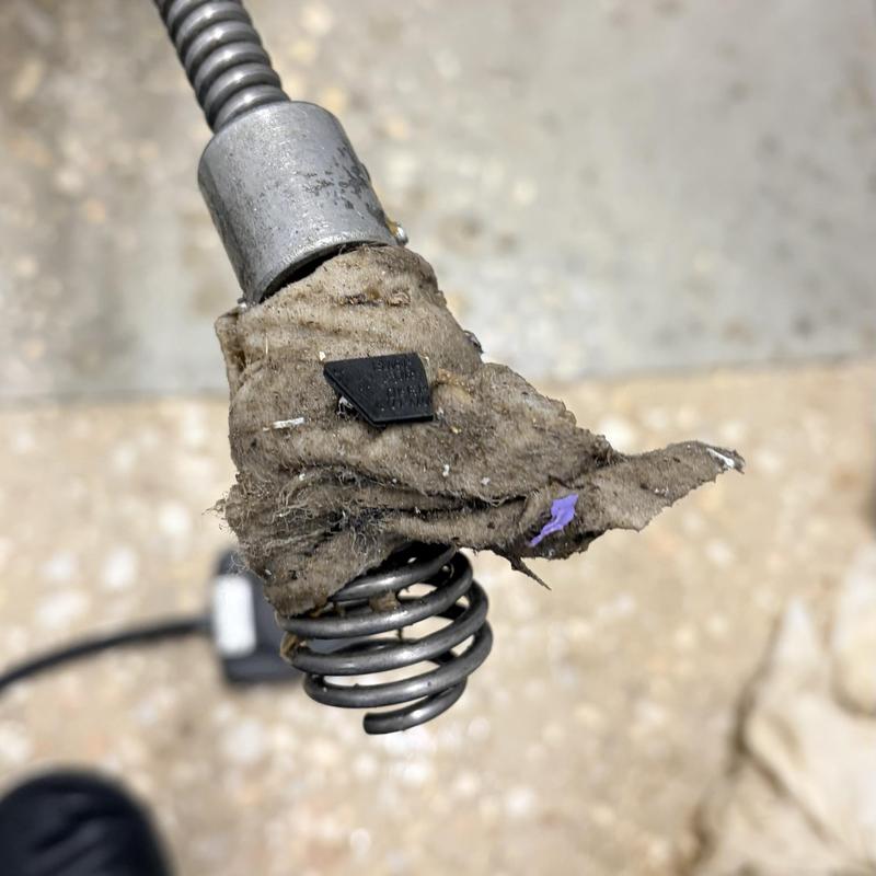 Sewer cleaning auger with wet wipe blockage removed