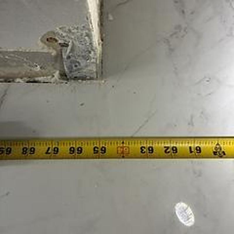 Hot water heater installation measuring tape close-up