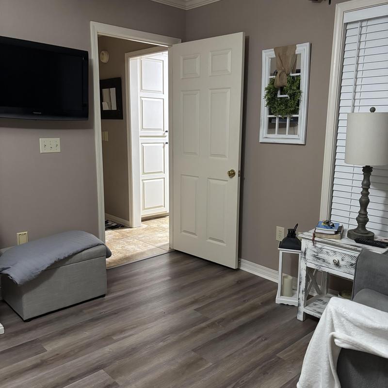 Vinyl flooring and quarter round installation in living room