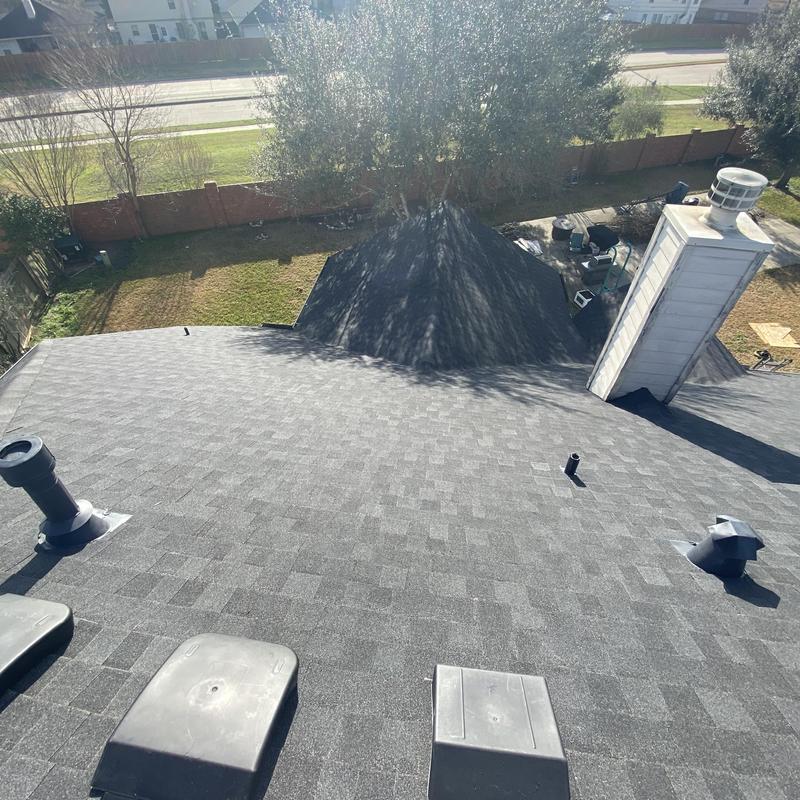 Architectural asphalt shingle roof with vent pipes and chimney