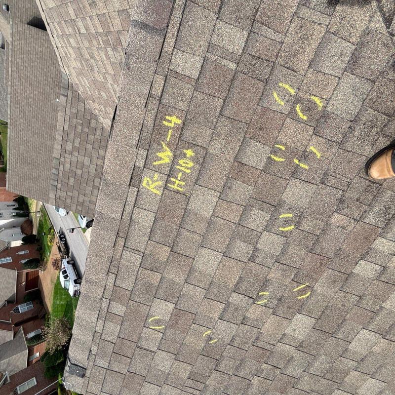 Asphalt shingle roof with marked hail damage
