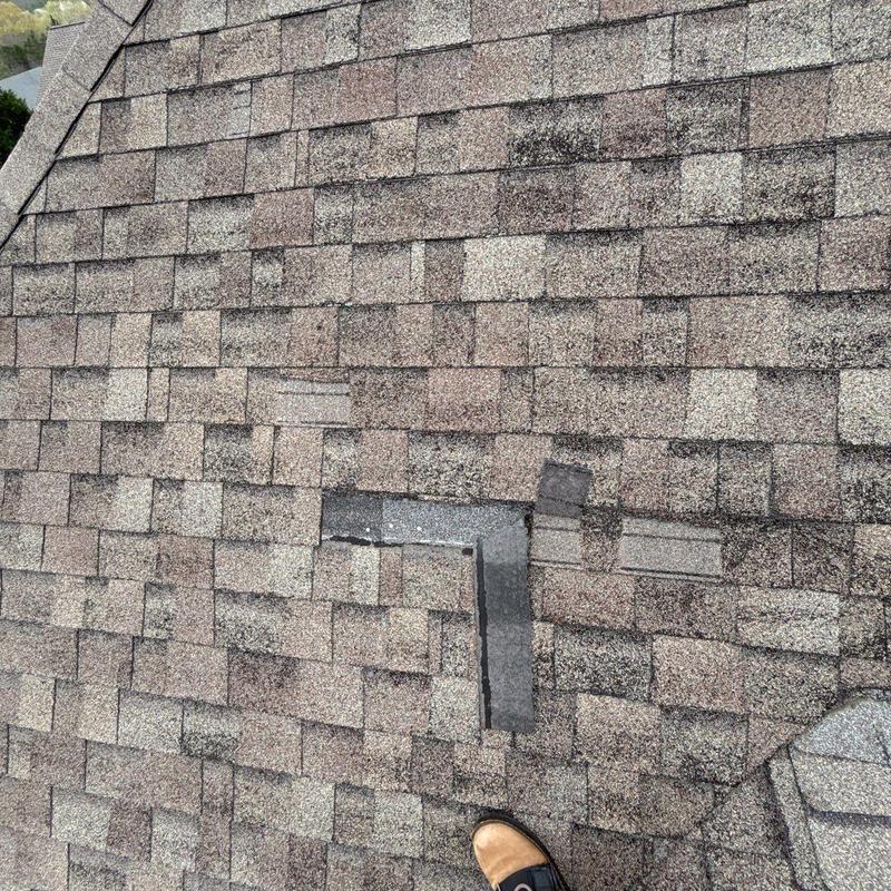 Asphalt shingle roof with hail damage and patch repair