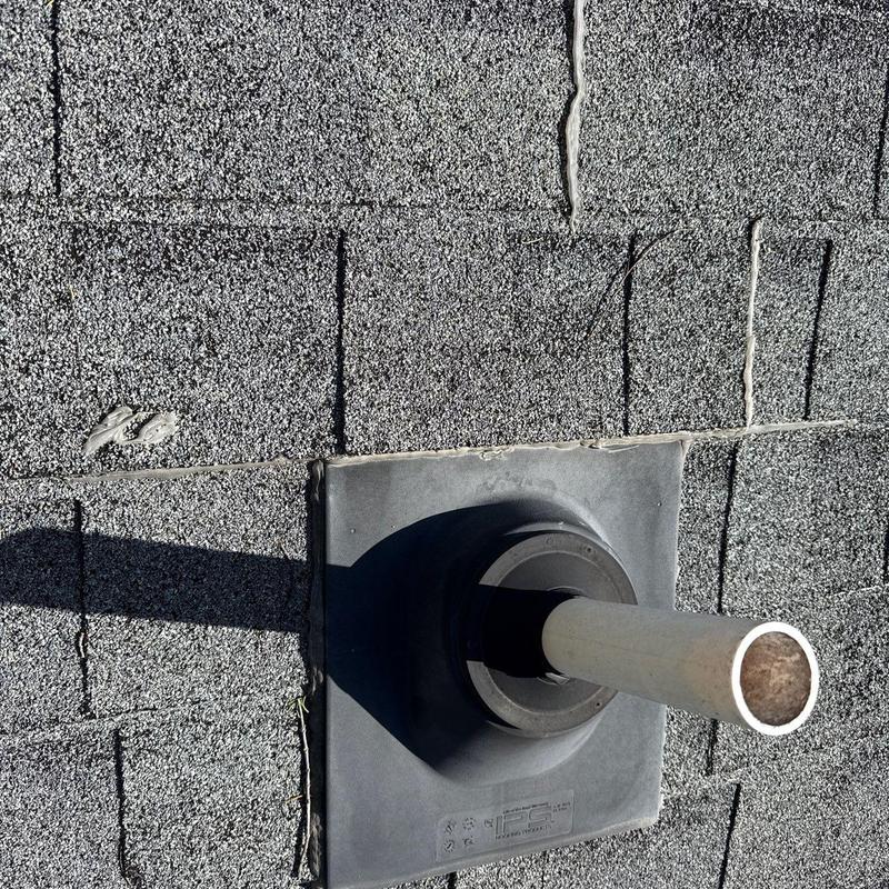 Roof pipe flashing on asphalt shingles with sealant