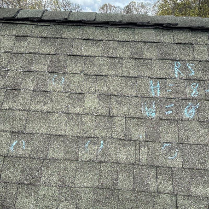 Asphalt shingle roof with hail damage markings