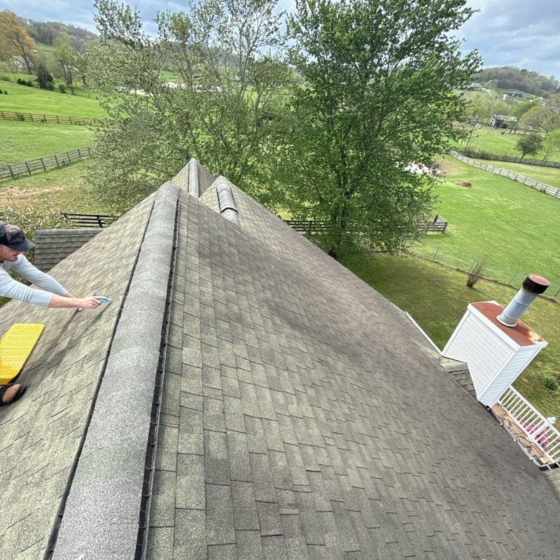 Roof shingles with hail damage inspection on residential roof