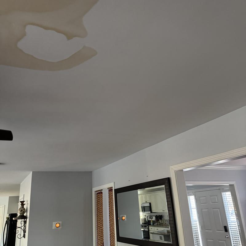 Ceiling water damage and stain from plumbing leak
