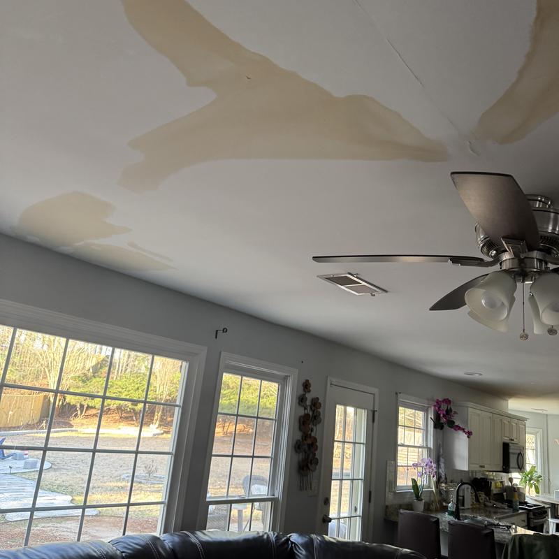 Ceiling water stains from plumbing leak in living room